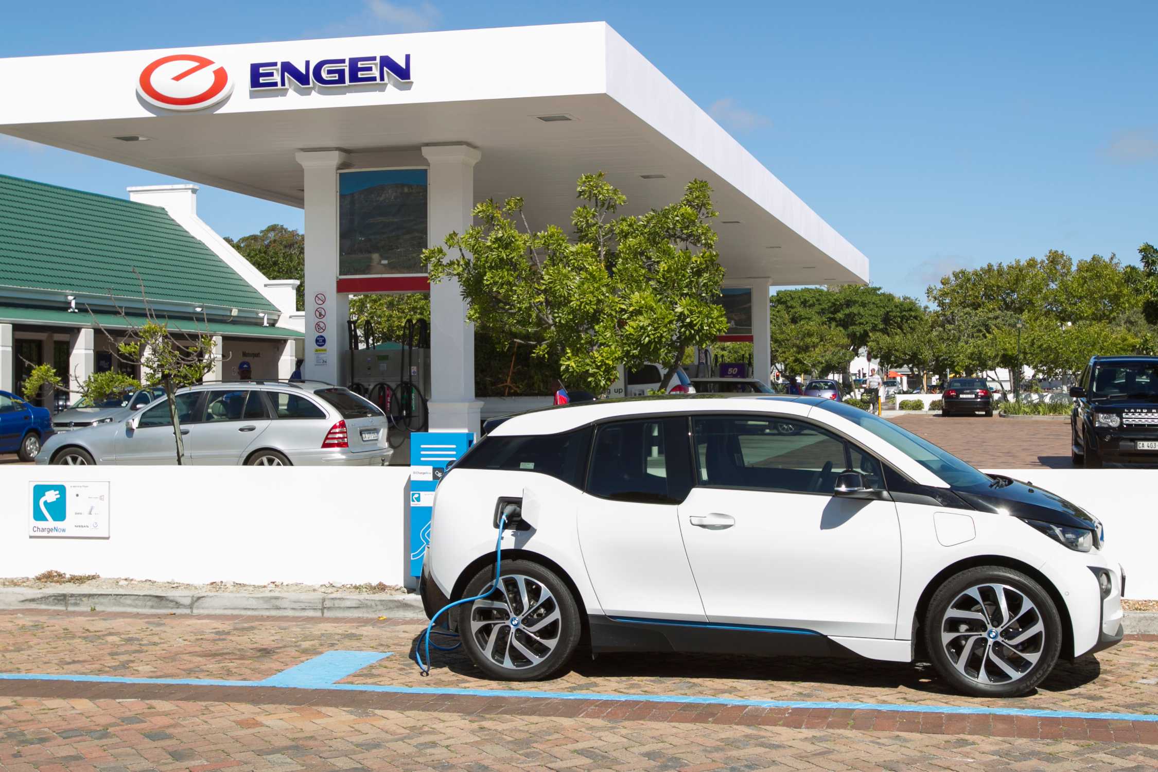 A BMW i3 connected to a public electric-vehicle charger at Constantia Village in Cape Town